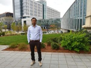 Dr. Nasir International Career Development Exchange standing in front of buildings.